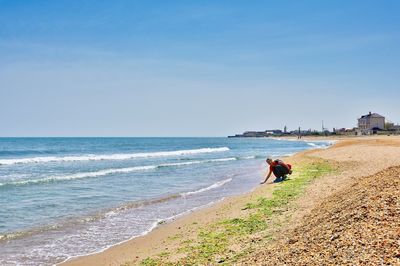 People on beach against sky
