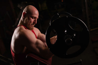 Shirtless man exercising in gym