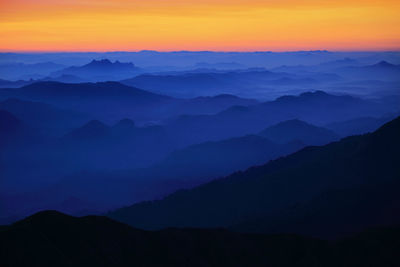 Scenic view of silhouette mountains against sky during sunset