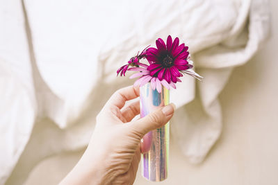 Midsection of woman holding flower