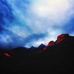 Scenic view of mountains against cloudy sky