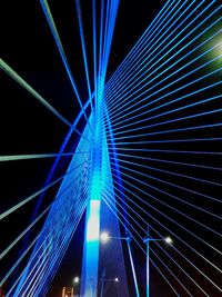 Low angle view of illuminated bridge at night