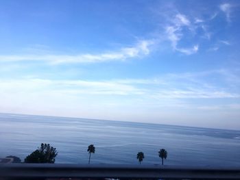 View of calm beach against blue sky