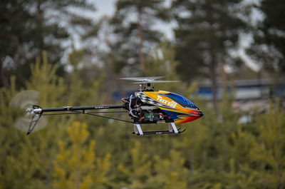 Close-up of bicycle flying over trees