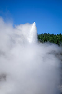 Low angle view of waterfall against sky