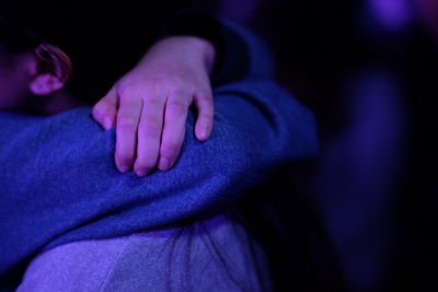 Close-up of hand on purple finger