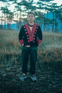 Portrait of teenage girl standing on land