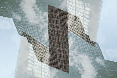 Low angle view of modern glass building against sky