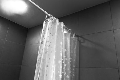 Curtain hanging in bathroom at home