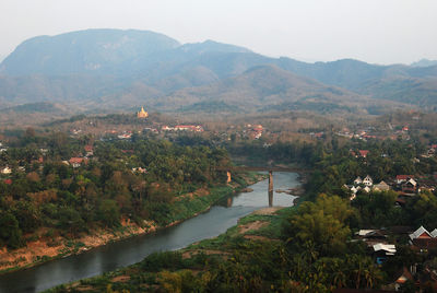 High angle view of lake and mountains against sky