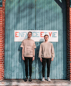 Full length of man standing against wall