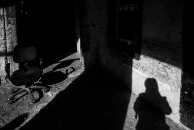 Shadow of man on tiled floor