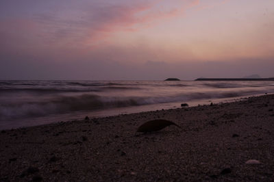 Scenic view of beach against sky during sunset