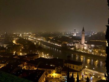 High angle view of city lit up at night