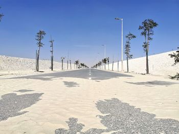 View of snow covered road against clear sky