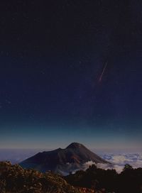 Low angle view of mountain against sky at night