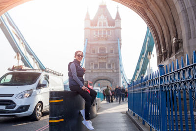 Young woman on bridge in city