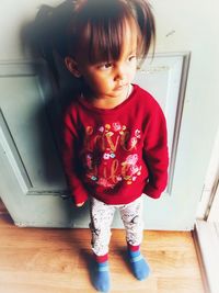 Cute boy standing on hardwood floor