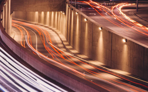 High angle view of light trails on multiple land highway at night