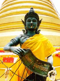 Low angle view of statue against temple