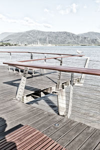 Empty pier on lake against sky