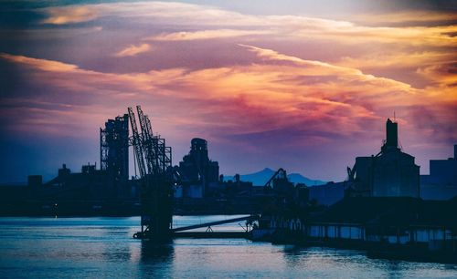 View of city at waterfront during sunset