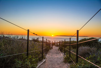 Enjoying an ocean sunset view from a hiking trail along the southern california coast. 