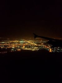 Aerial view of illuminated cityscape against sky at night