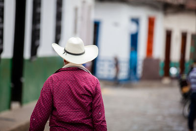 Local man wearing a traditional hat walking at the streets of concepcion in antioquia, colombia.
