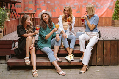 Women sitting in a drinking glass