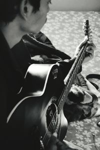 Close-up of man playing guitar