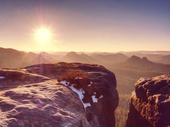 Rocky hill above inverse mist. winter cold weather in mountains colorful fog. misty valley in winter