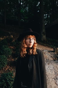 Young woman standing in forest