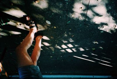 Low section of woman standing on tiled floor
