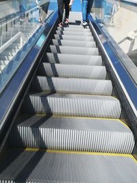 Low section of people on escalator