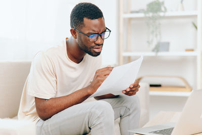 Young man using laptop at home