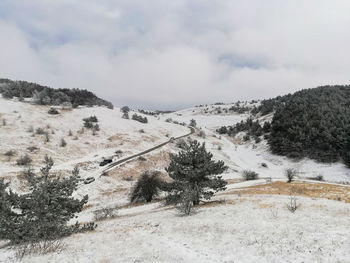 Scenic view of snow covered land against sky