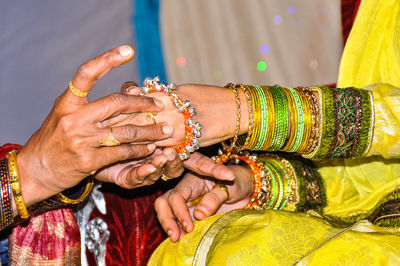 Close-up of womens hands in indian wedding ceremony