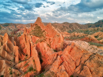 Scenic view of mountains against cloudy sky