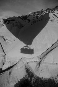 Shadow on hot air balloon on snowcapped mountain