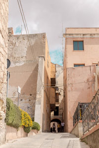 Street amidst buildings against sky