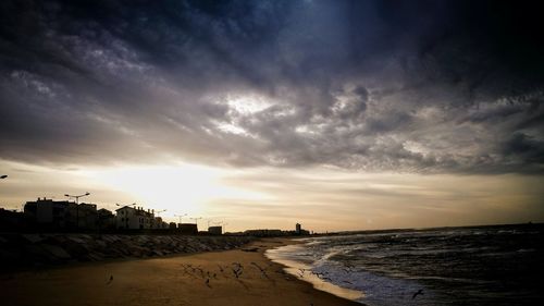 View of beach against cloudy sky