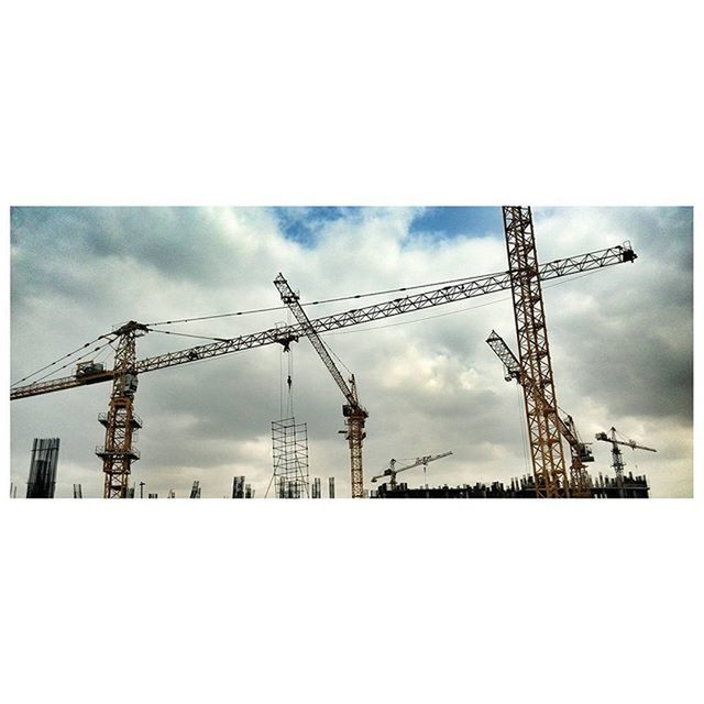 fuel and power generation, sky, technology, industry, crane - construction machinery, electricity pylon, construction site, weather, transfer print, electricity, power supply, crane, built structure, wind power, auto post production filter, cloud - sky, construction, low angle view, winter, development