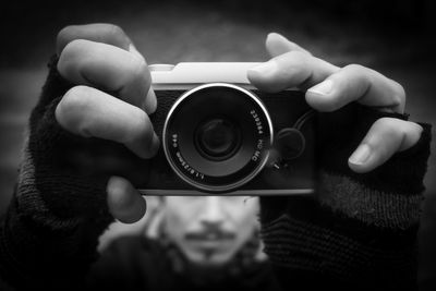 Close-up of man hands holding camera