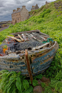 High angle view of abandoned boat on field against sky