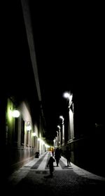 Silhouette of man on road at night