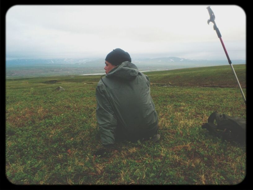 transfer print, sky, grass, landscape, rear view, tranquil scene, tranquility, auto post production filter, field, scenics, lifestyles, nature, leisure activity, standing, beauty in nature, men, full length, casual clothing