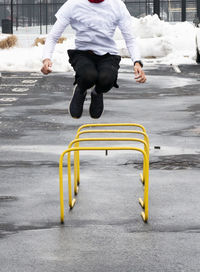 Low section of man running on road