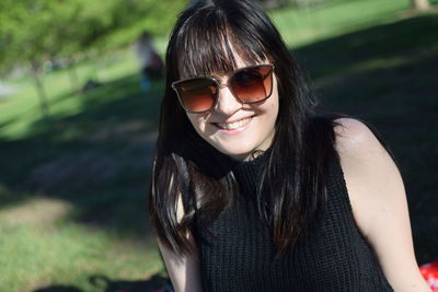 Portrait of smiling young woman wearing sunglasses