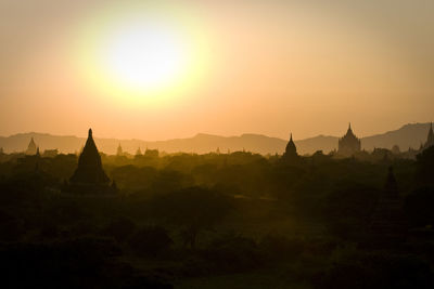 Temples at bagan archaeological zone against sky during sunset